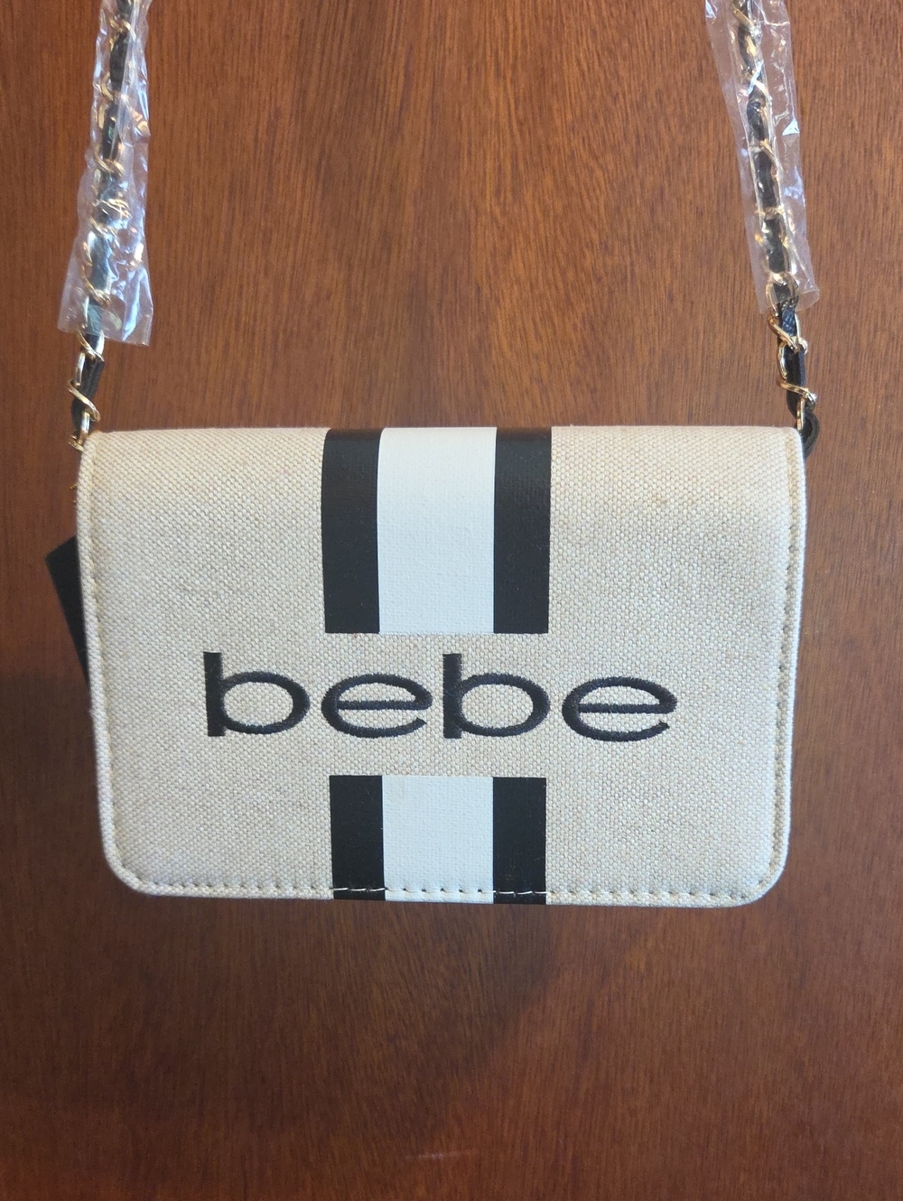 bebe Cream Crossbody Bag with Black Stripe Detail